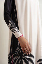Black and white patterned sleeve with floral design on a plain background