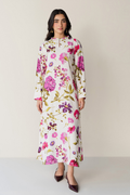 Woman wearing a floral dress against a plain background
