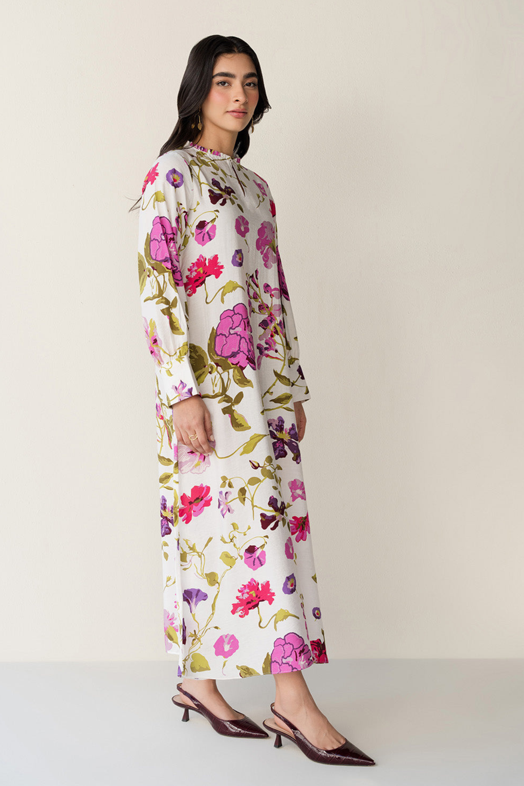 Woman wearing a floral dress on a plain background