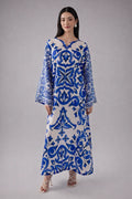 Woman wearing a blue and white patterned dress on a gray background