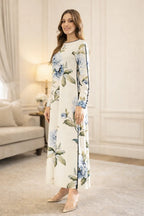 Woman wearing a floral dress in a living room setting