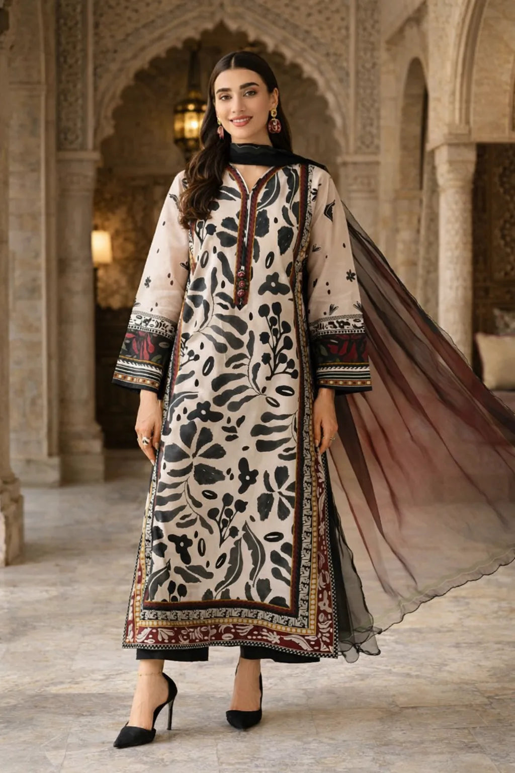 Woman wearing a traditional outfit with a patterned dress and long scarf in an ornate interior setting.