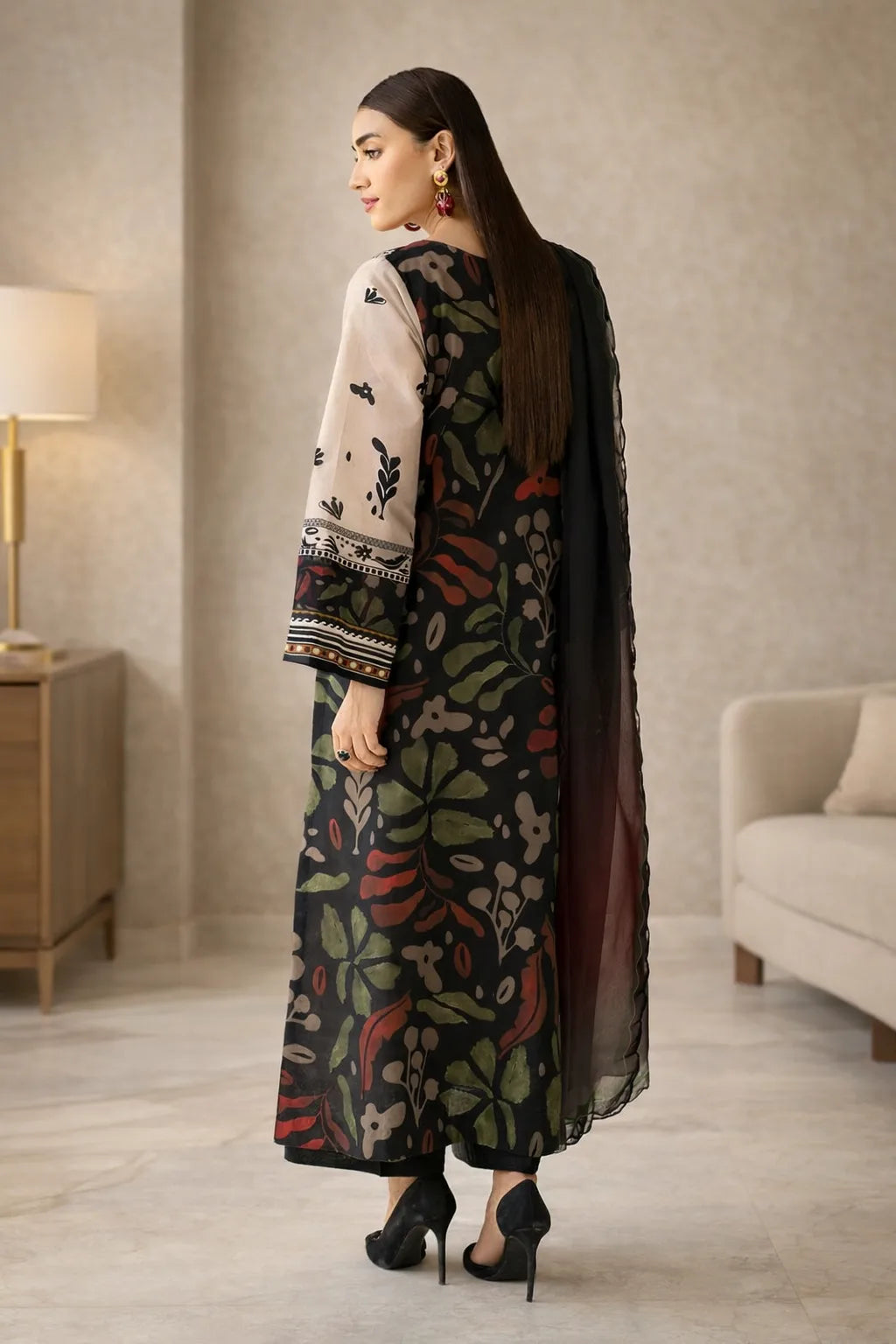 Woman in a floral dress standing in a room with a lamp and sofa.
