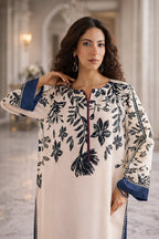 Woman wearing a floral-patterned outfit with a blurred indoor background