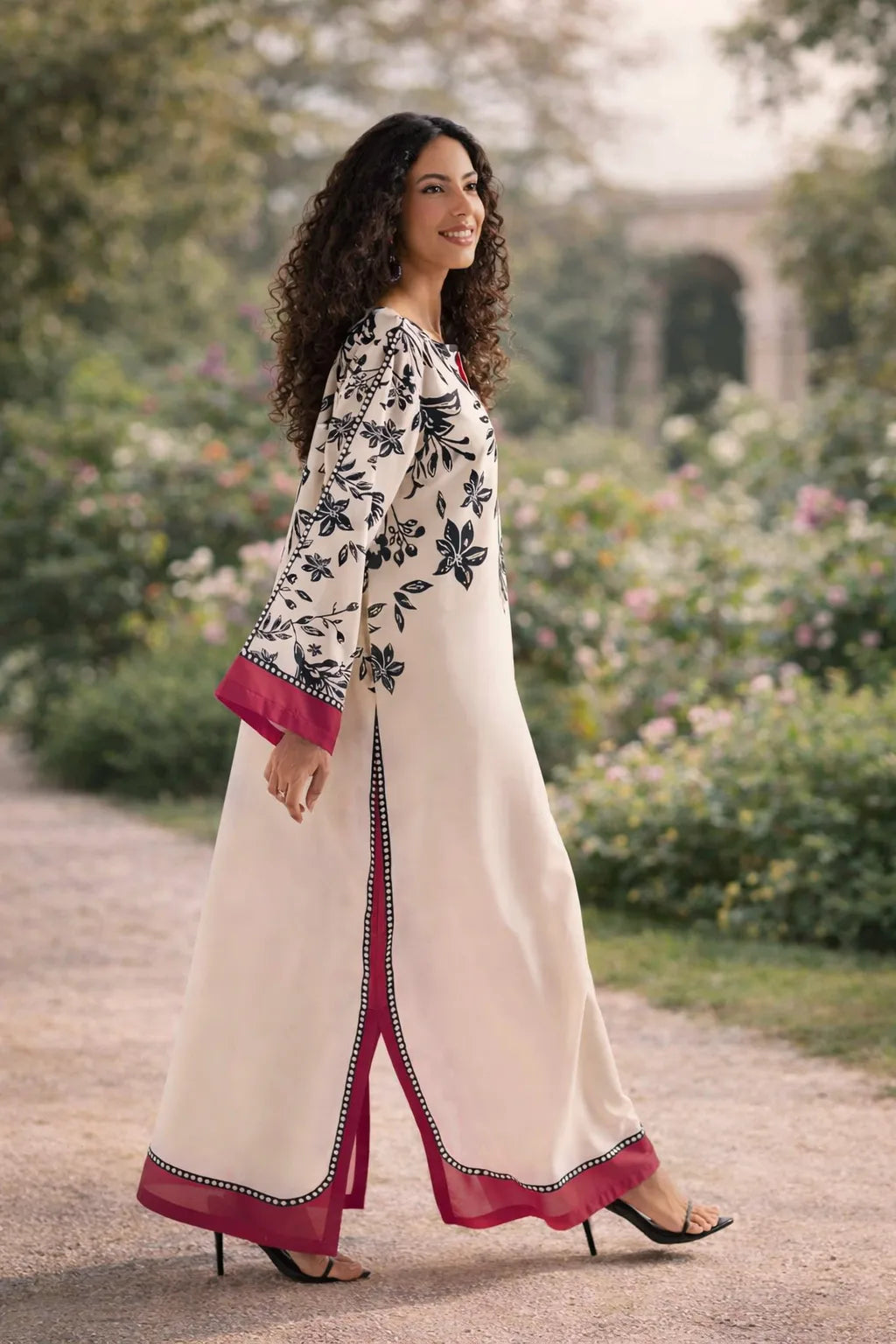 Woman in a floral dress walking in a garden