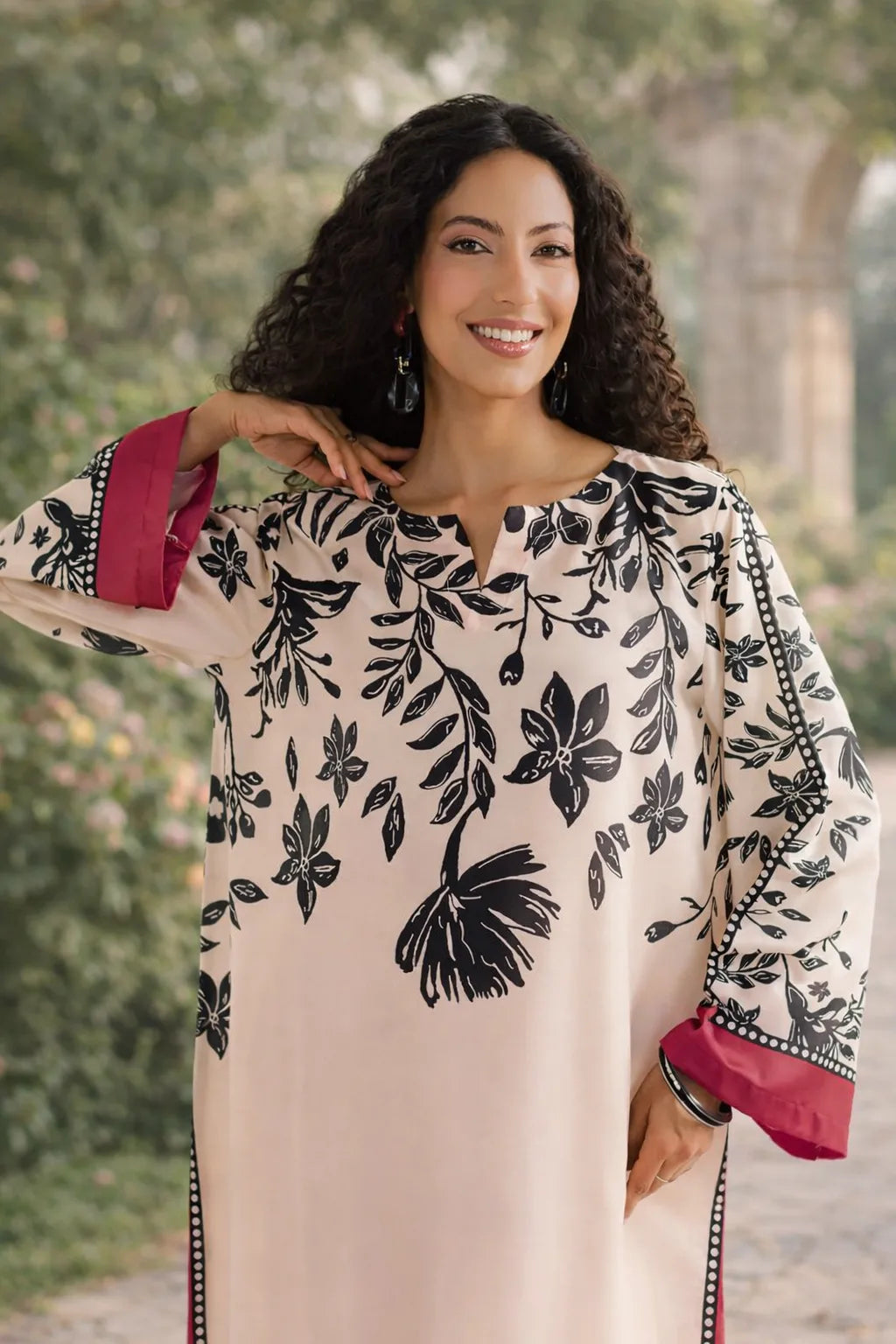 Woman wearing a floral dress with pink sleeves outdoors
