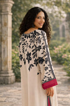 Woman wearing a floral off-shoulder top with a blurred garden background